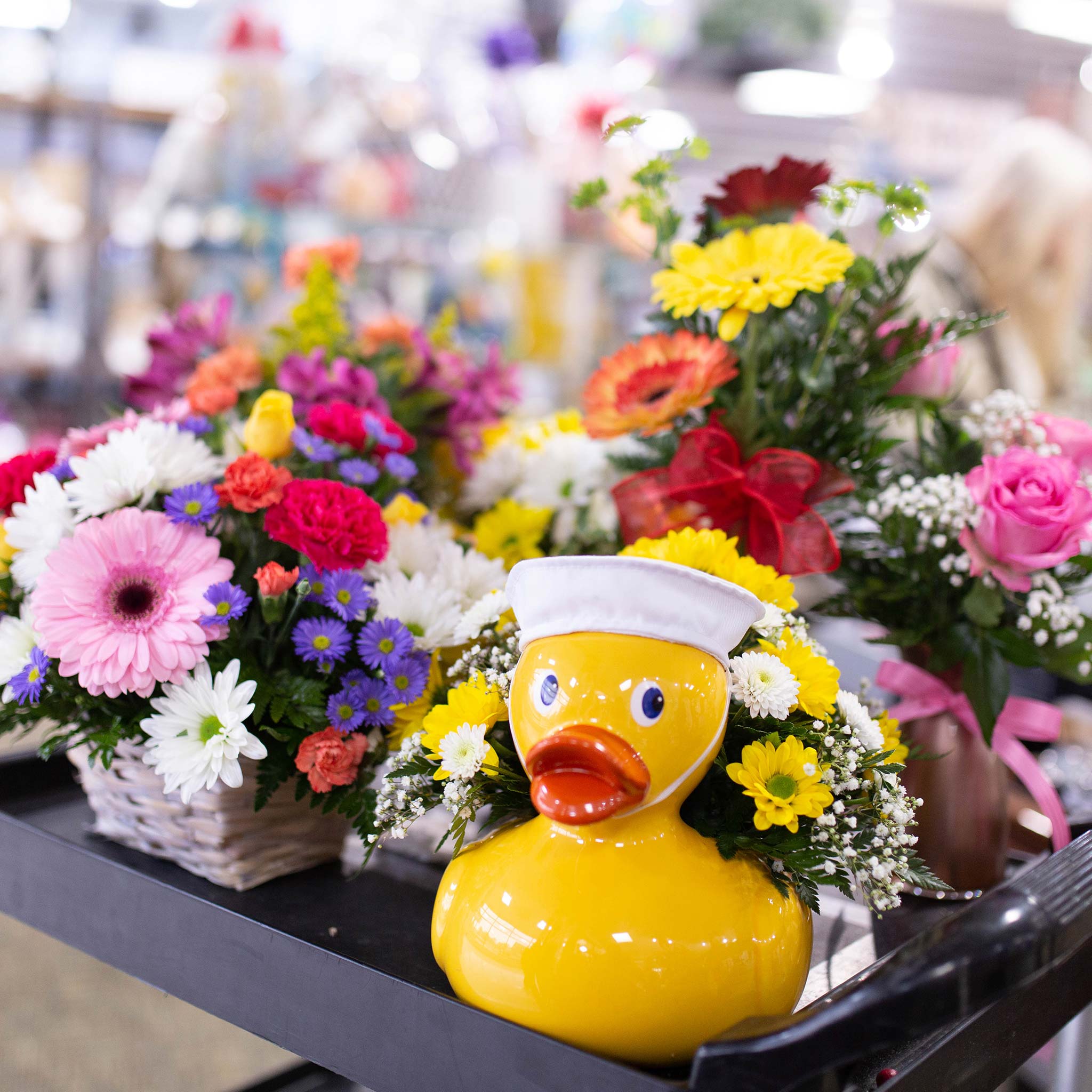 A variety of colorful flowers on a cart